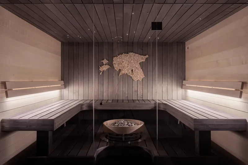 Warm wooden sauna-style relaxation room with soft lighting